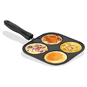 Four-section pancake pan with cooked pancakes on a white background