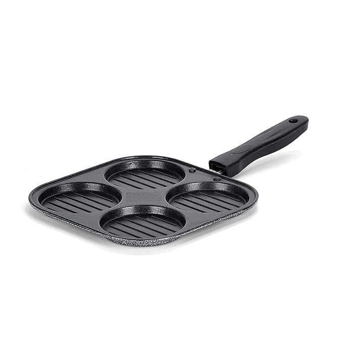 Black cast iron skillet with multiple cooking compartments on a white background