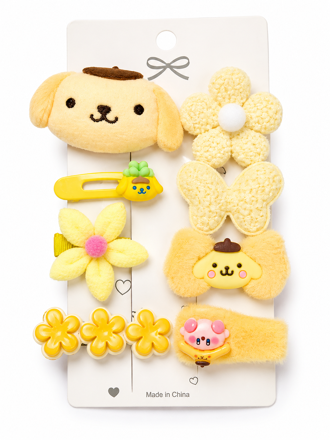 Set of yellow hair accessories with dog and flower designs on a white card.