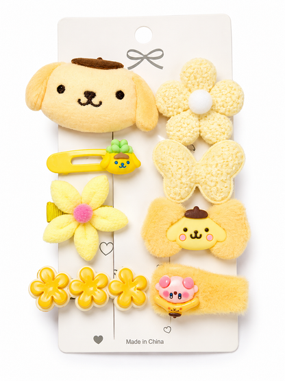 Set of yellow hair accessories with dog and flower designs on a white card.