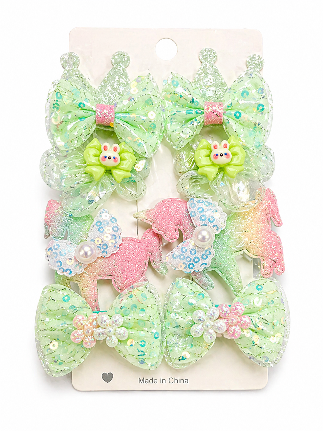 Pastel-colored hair bows with decorative elements on a white card.