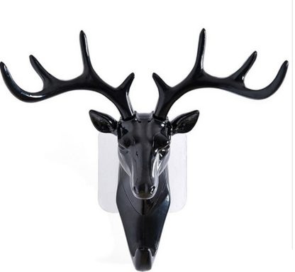 Black deer head wall decoration on a white background